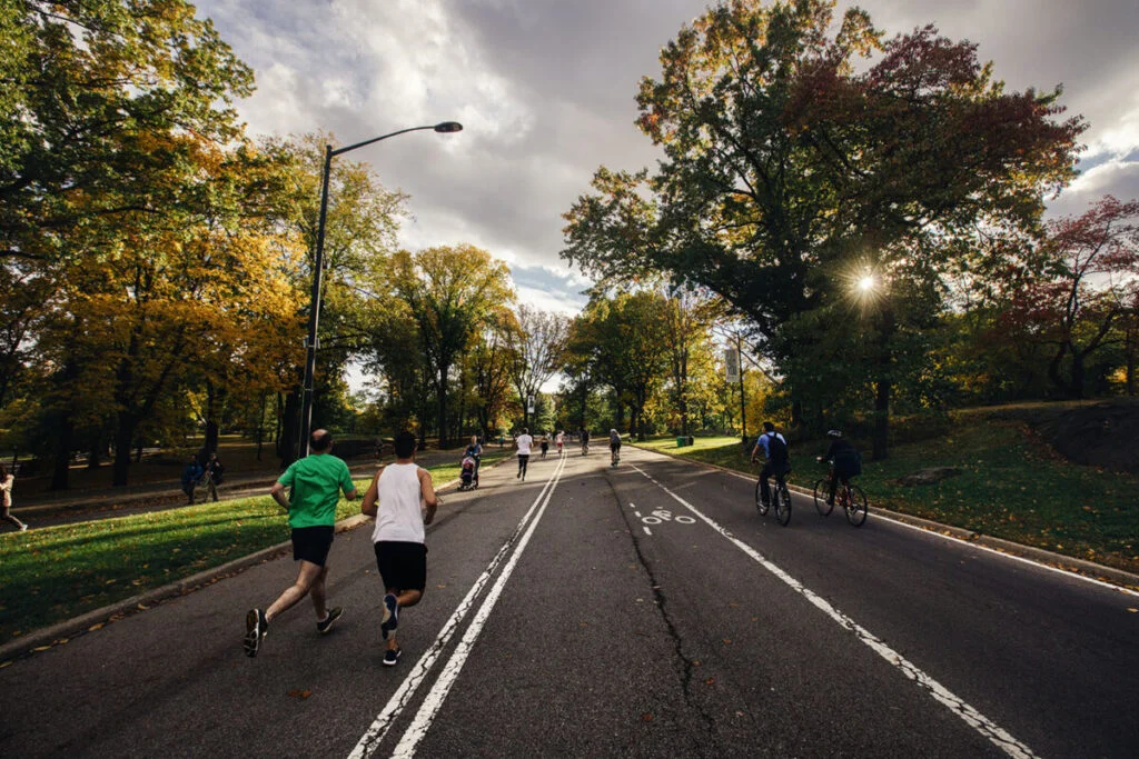 People running on a sunny day in Central Park in Manhattan, New York City