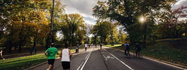 People running on a sunny day in Central Park in Manhattan, New York City