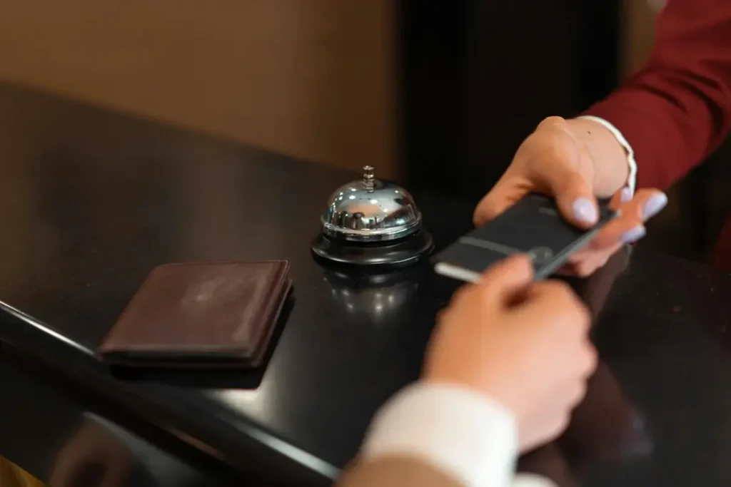 close up of a guest's hands checking in at a hotel